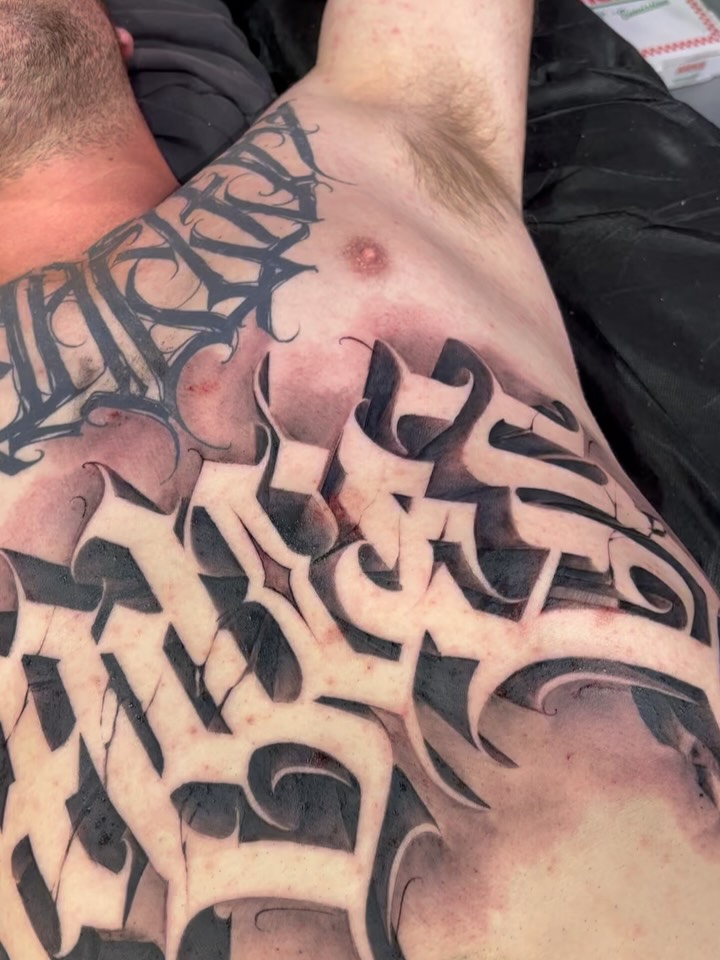 Massive blackletter script with bold shading on chest