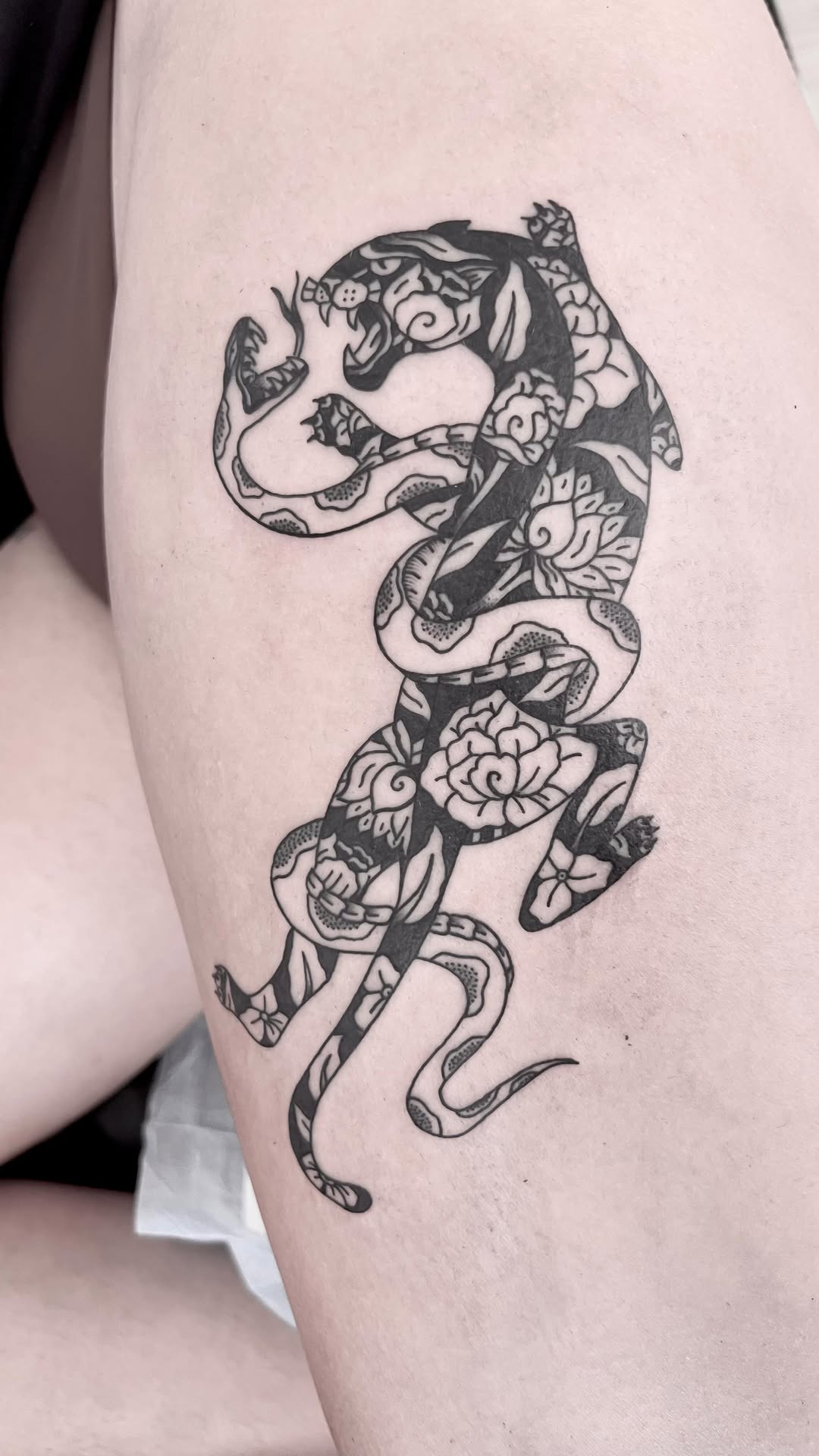Bold blackwork panther silhouette filled with ornate floral motifs