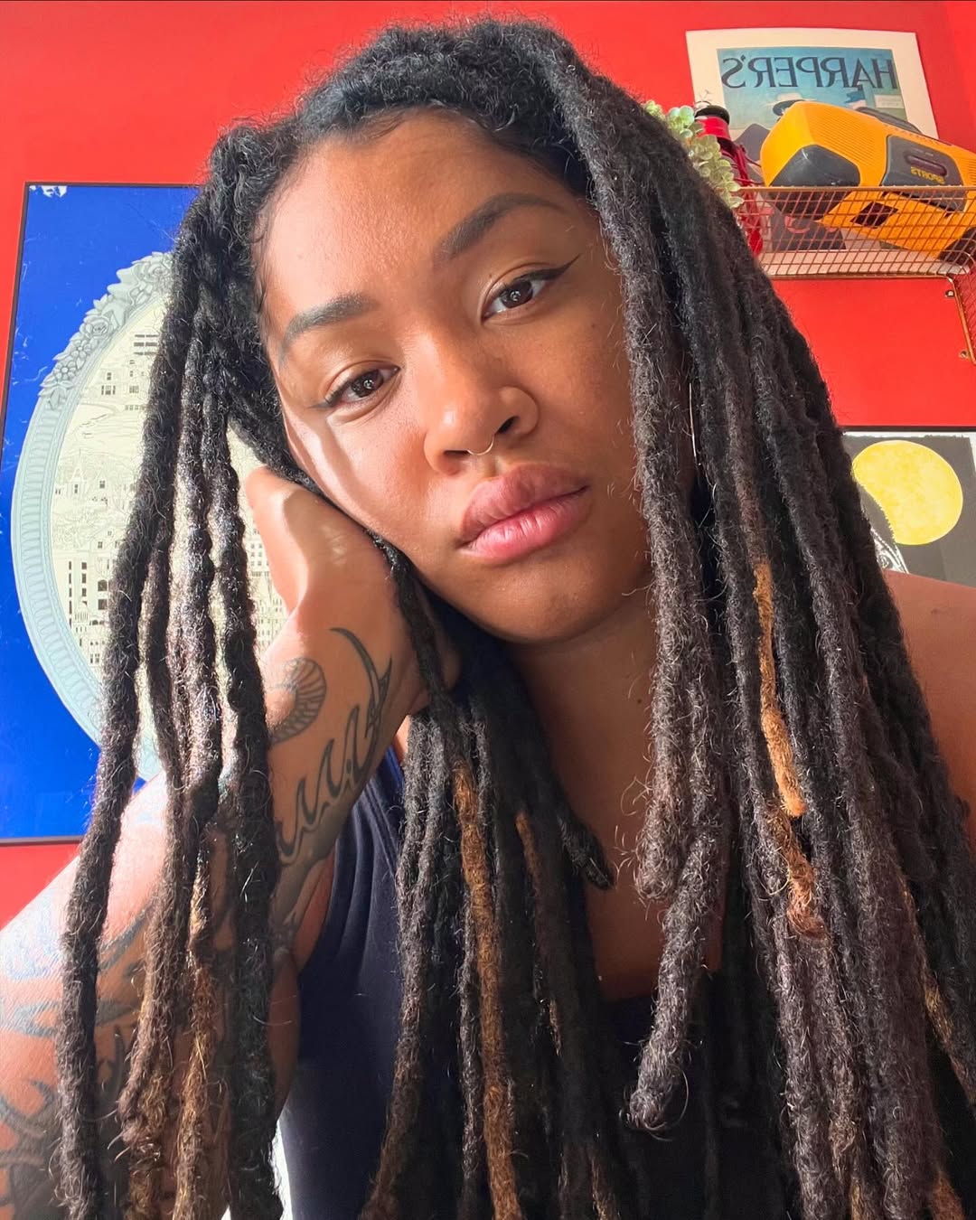 Bold black forearm text with flowing script lines