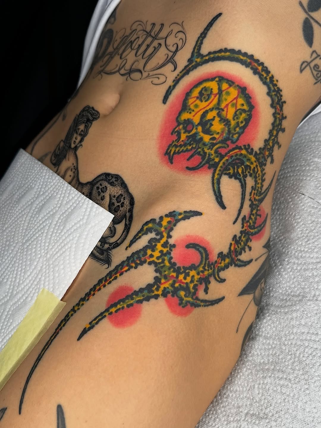 Bold zombie-traditional skull with neon halo and serpent