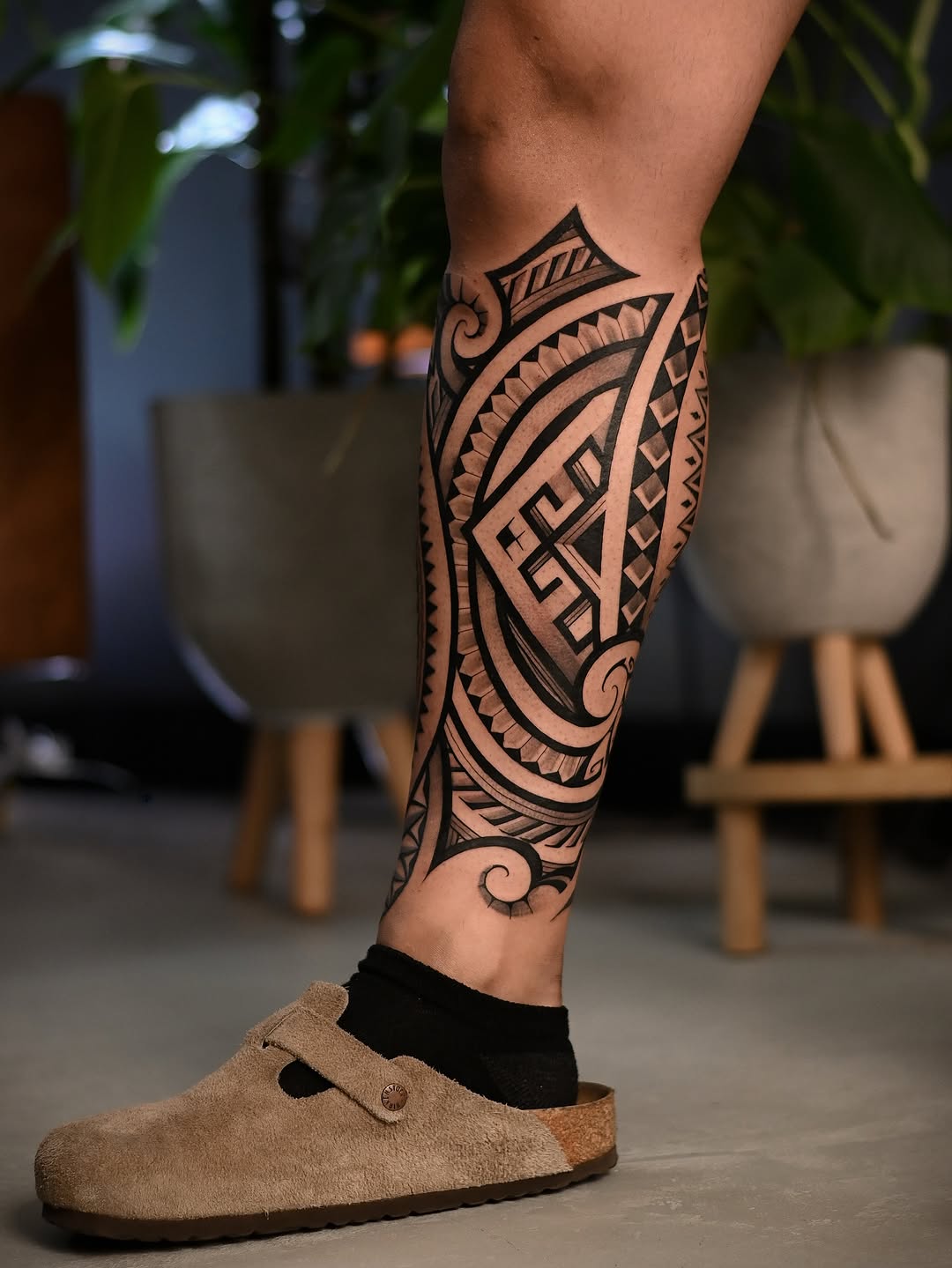 Bold geometric tribal leg wrap with intricate blackwork