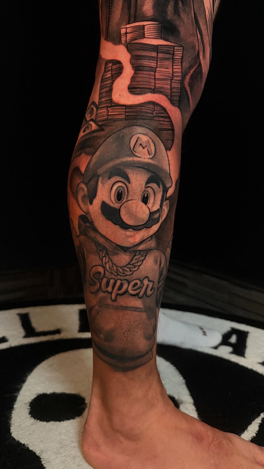 Bold Mario head portrait on calf with 'Super' banner