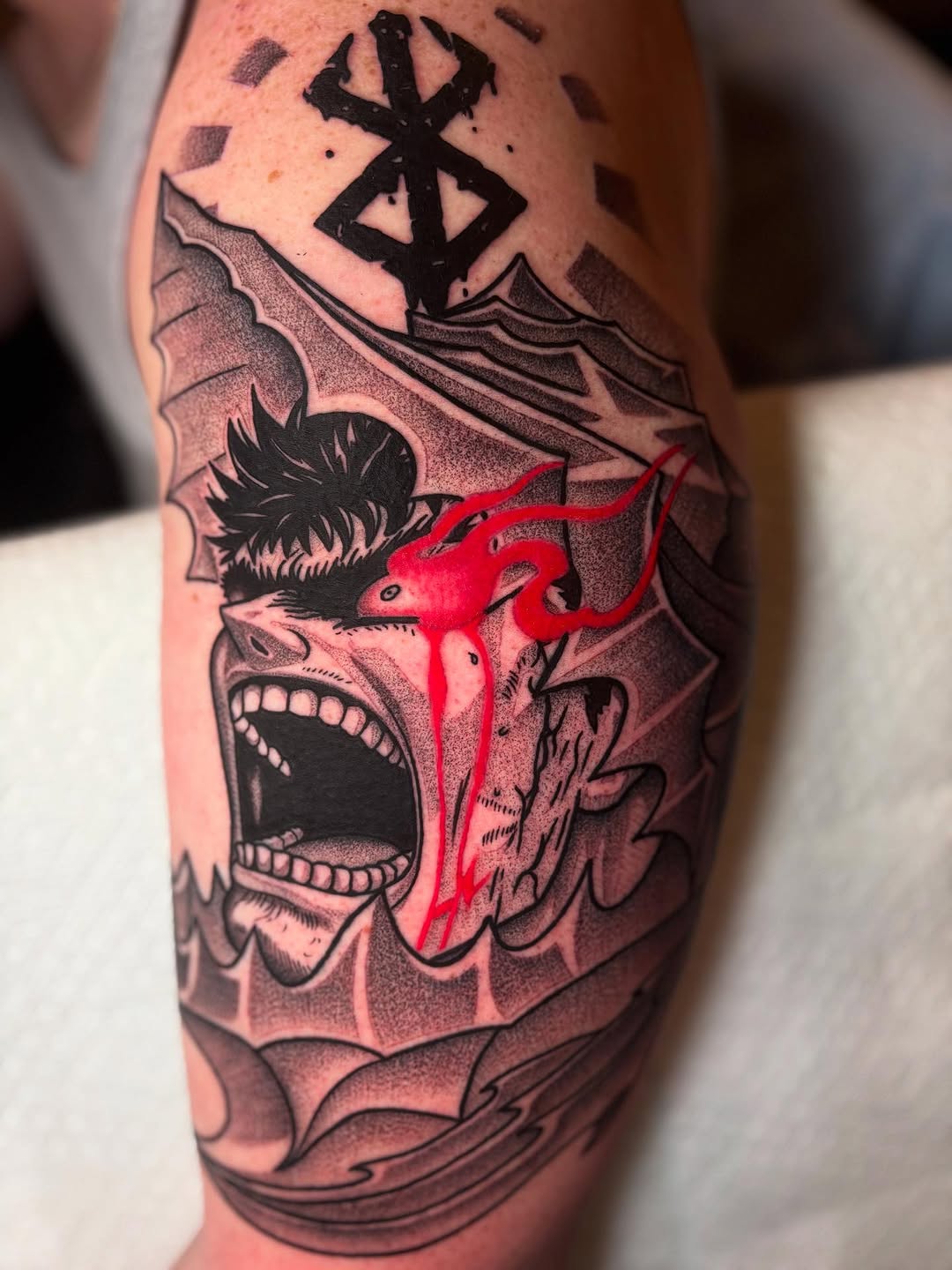 Bold blackwork Berserk-inspired scream, jagged waves, red gore accent