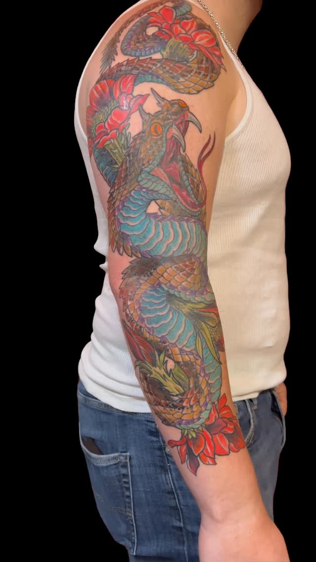 Vivid coiled snake with turquoise scales and red hibiscus