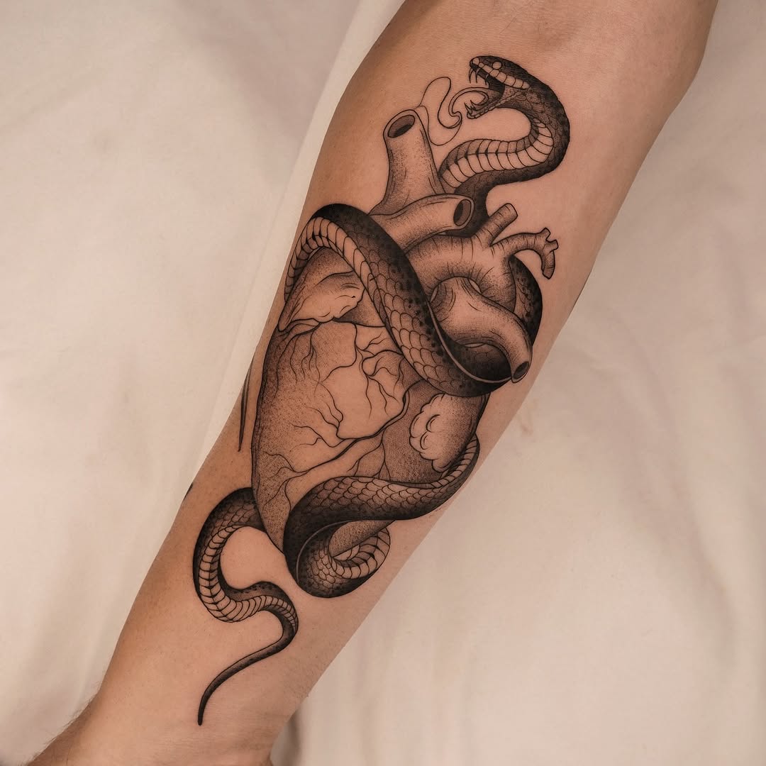 Striking snake-wrapped anatomical heart with meticulous dotwork shading.