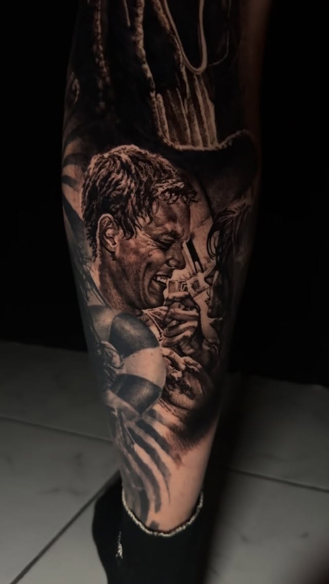 Hyper-detailed black-and-gray realism of a man's intense portrait