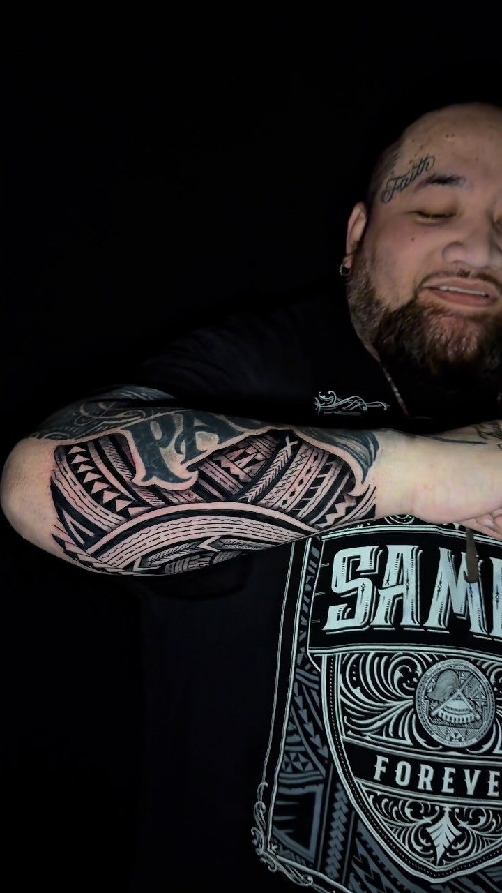 Bold Polynesian blackwork forearm tattoo with geometric patterns