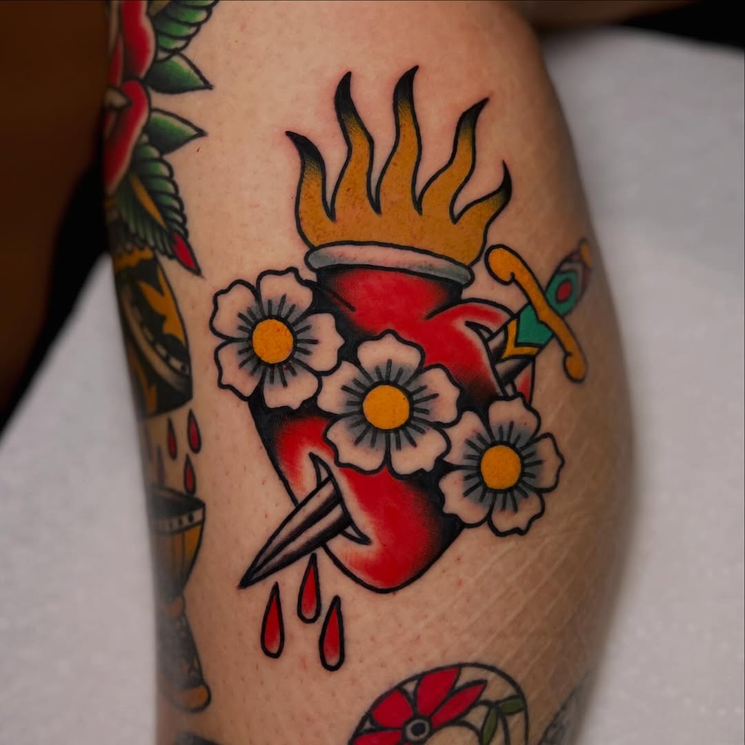 Bold traditional heart with flames and daisies, vibrant colors