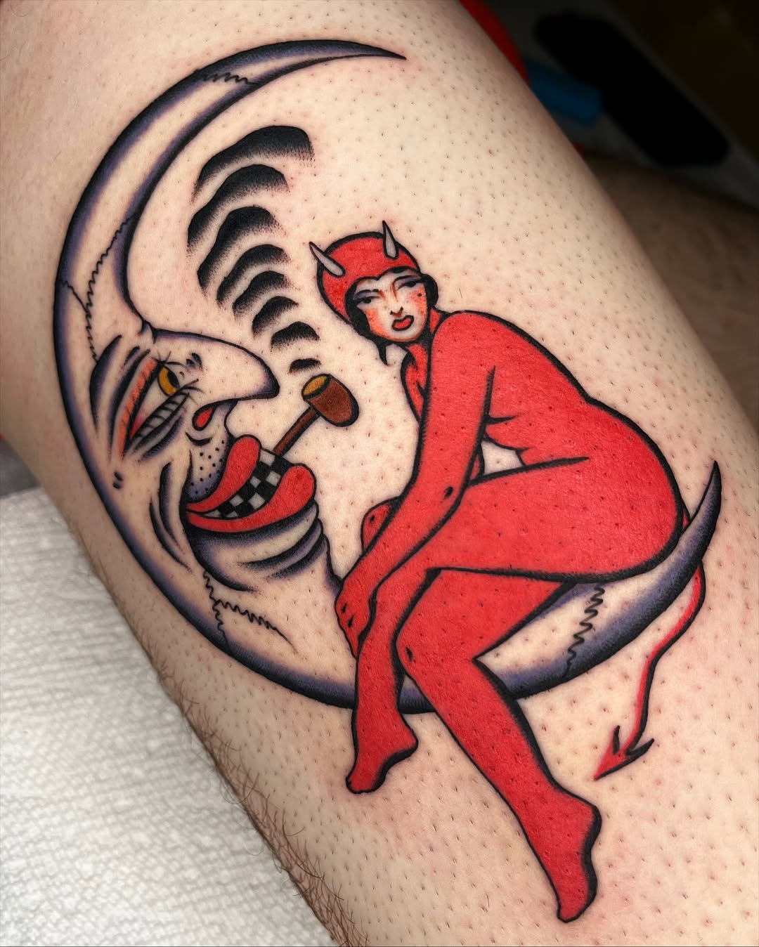 Bold traditional red devil riding a crescent moon