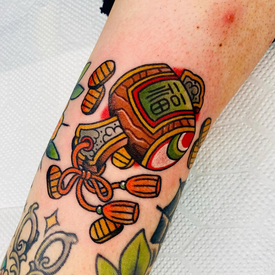 Bold neo-traditional amulet motif with tassels and vibrant color