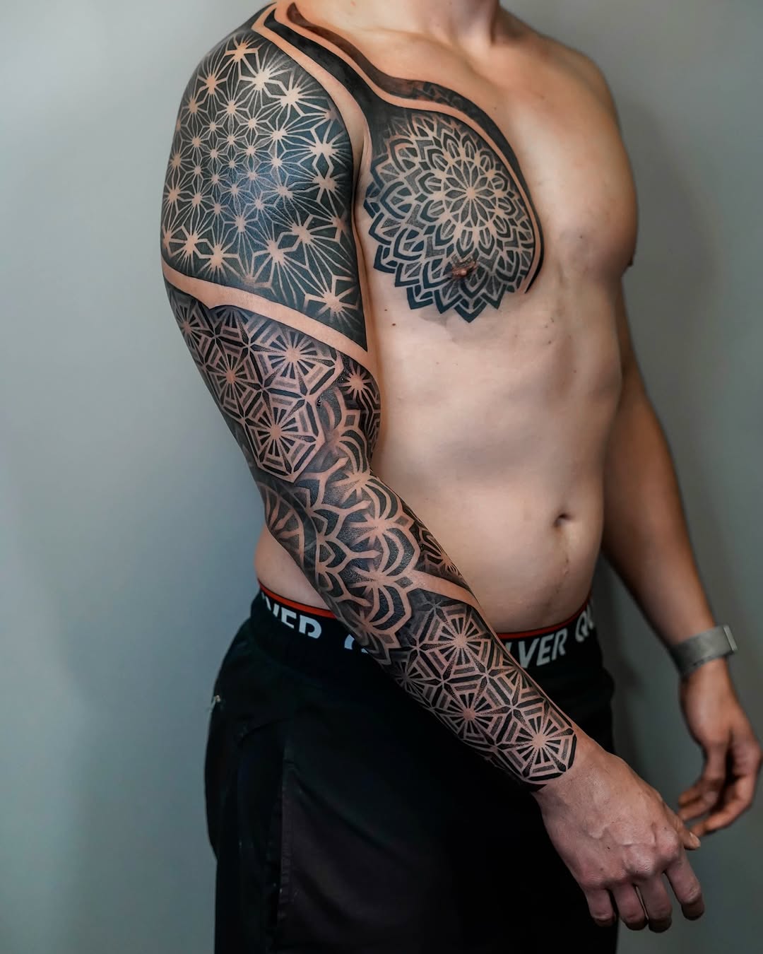 Bold geometric mandala sleeve with dense dotwork shading