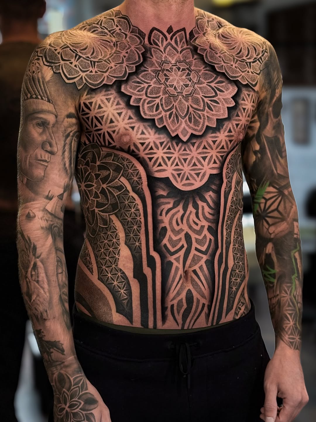 Symmetrical mandala dotwork spanning chest and abdomen