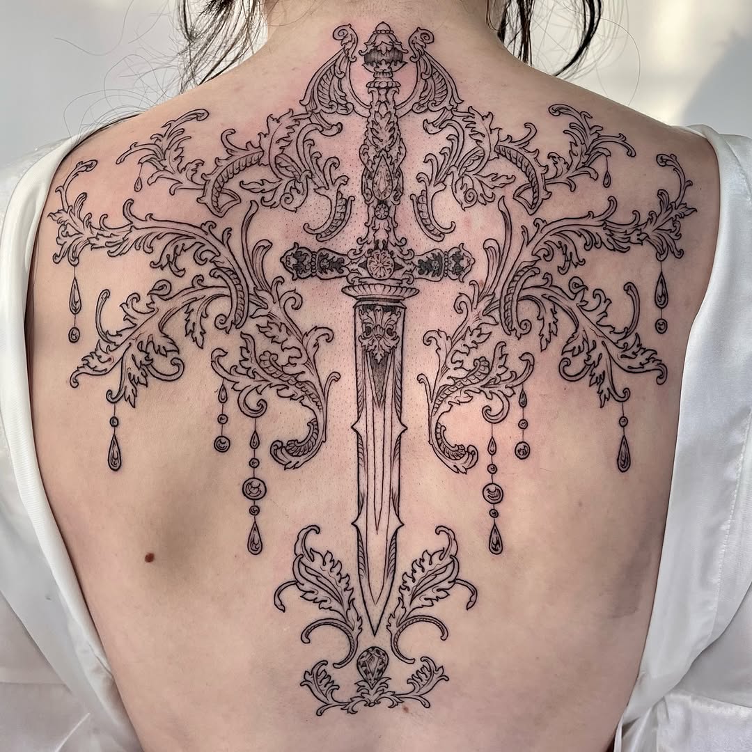 Ornamental dagger back piece with elaborate filigree