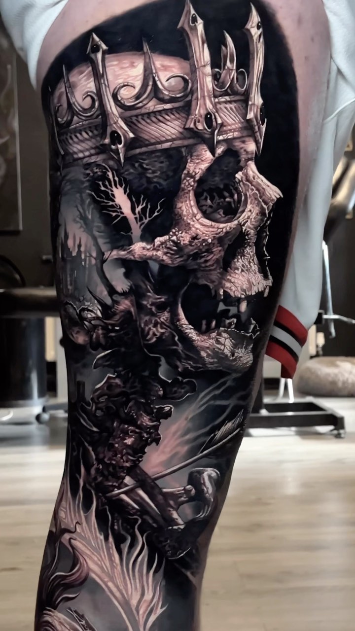 Monumental grayscale skull under ornate crown, forested backdrop.