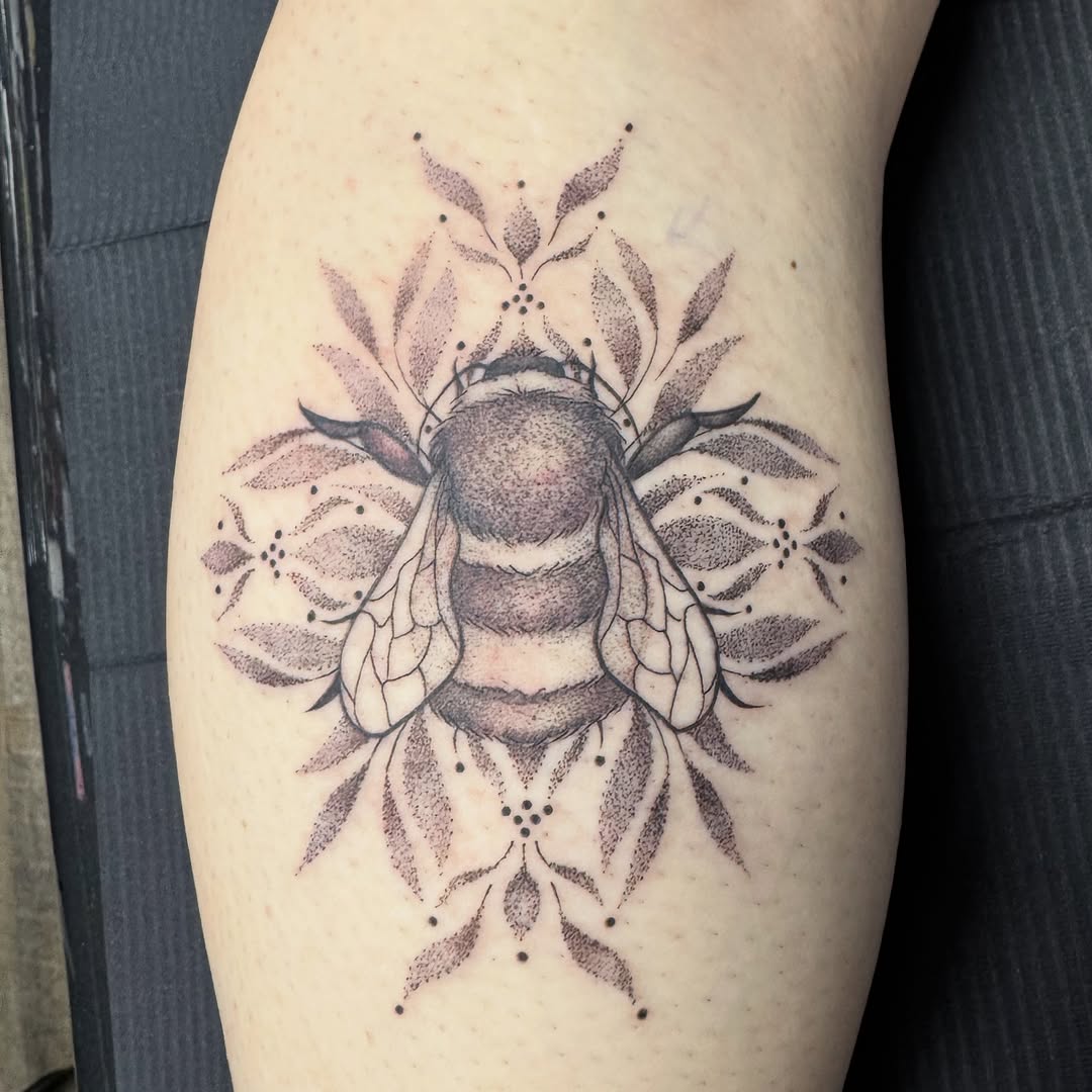 Ornamental bee tattoo with dotwork floral mandala