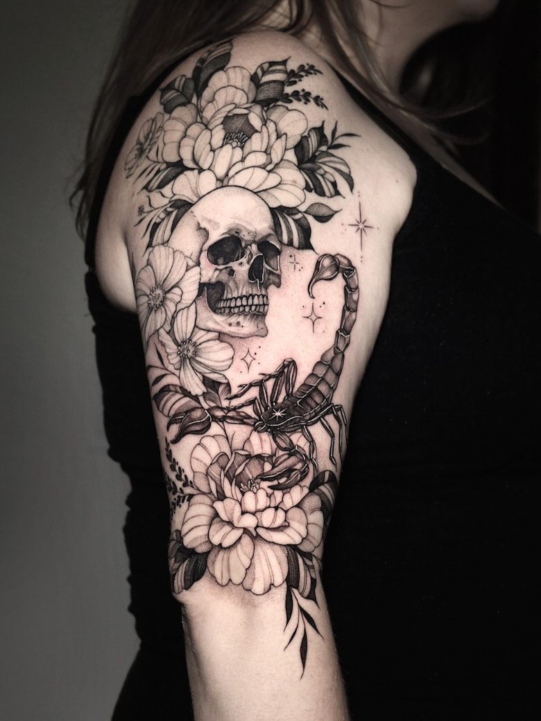 Elegant black-and-gray floral sleeve with skull centerpiece.