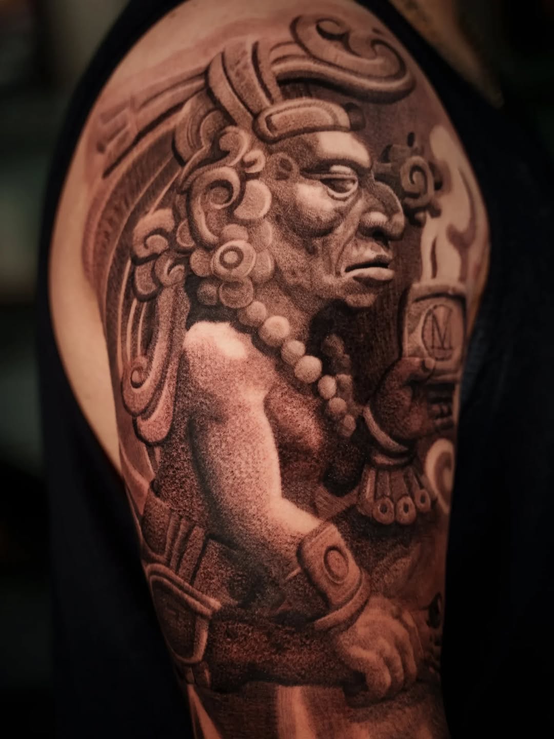 Ancient Aztec warrior carved in bold blackwork.