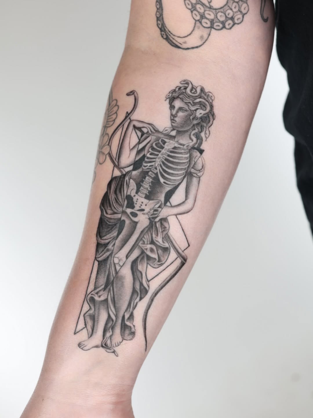 Engraving-style Medusa-inspired figure with skeletal ribcage and drapery
