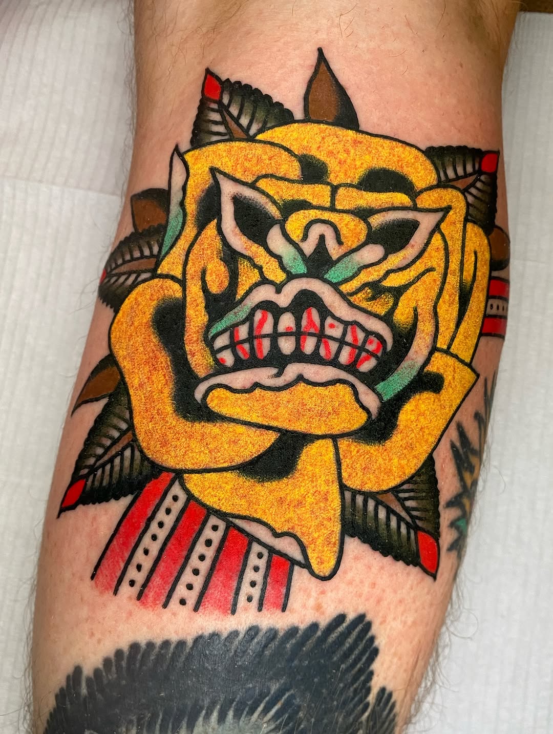 Vibrant neo-traditional yellow flower with snarling demon mask