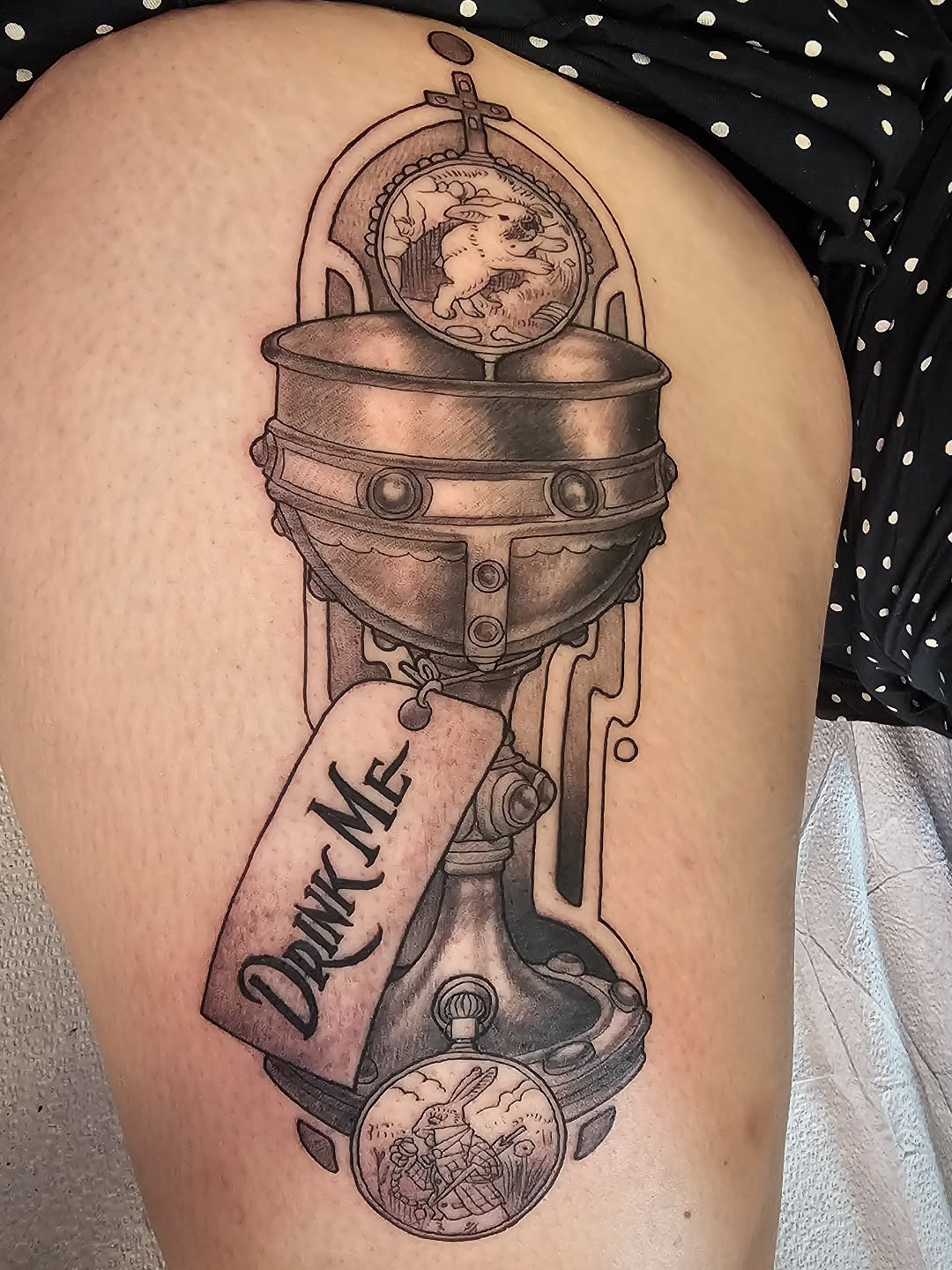 Intricate steampunk goblet with a 'Drink Me' tag.