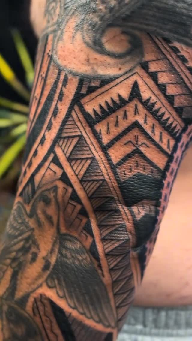 Intricate Polynesian geometric patterns in bold blackwork.