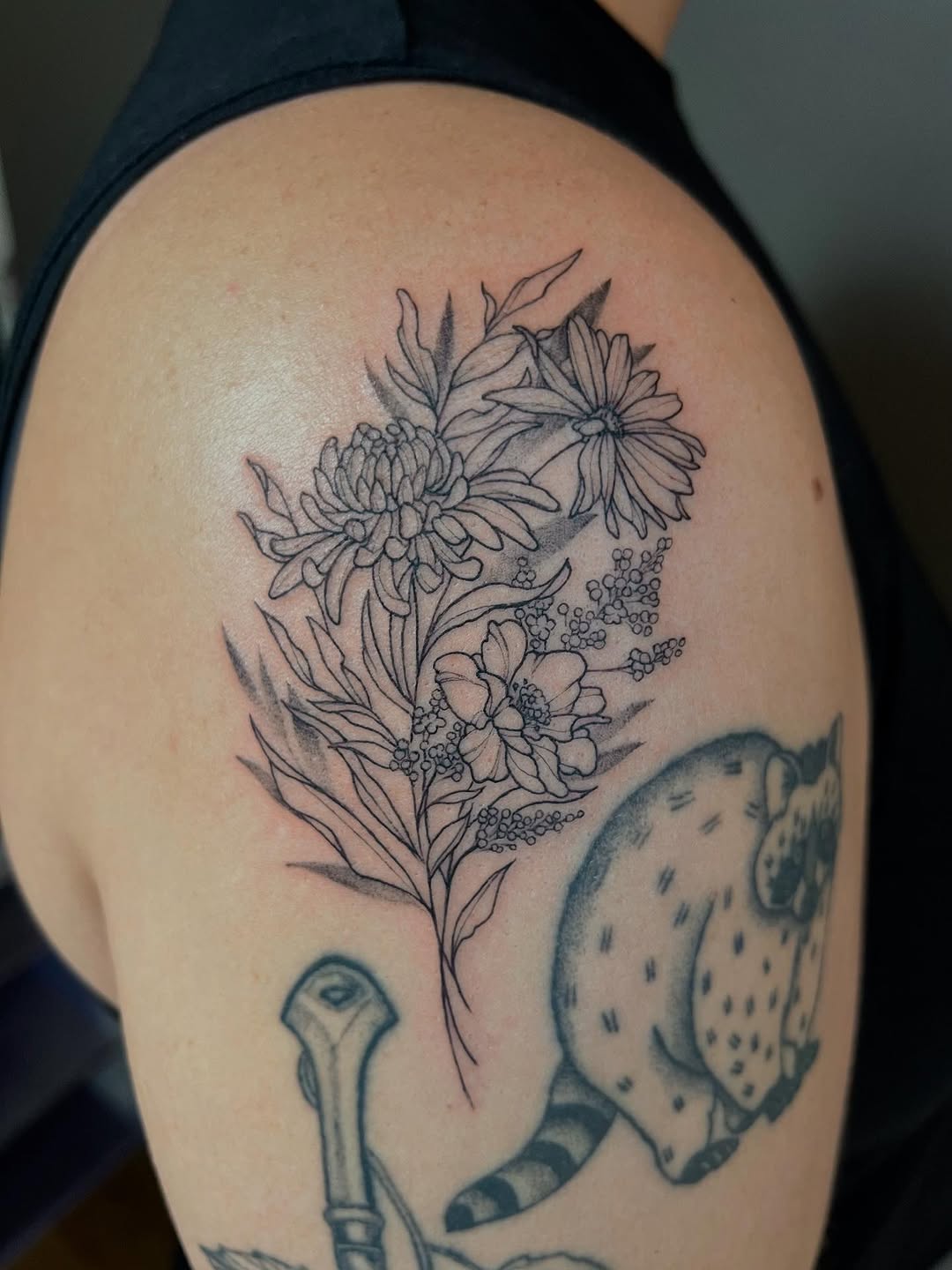 Delicate botanical bouquet in fine-line blackwork.