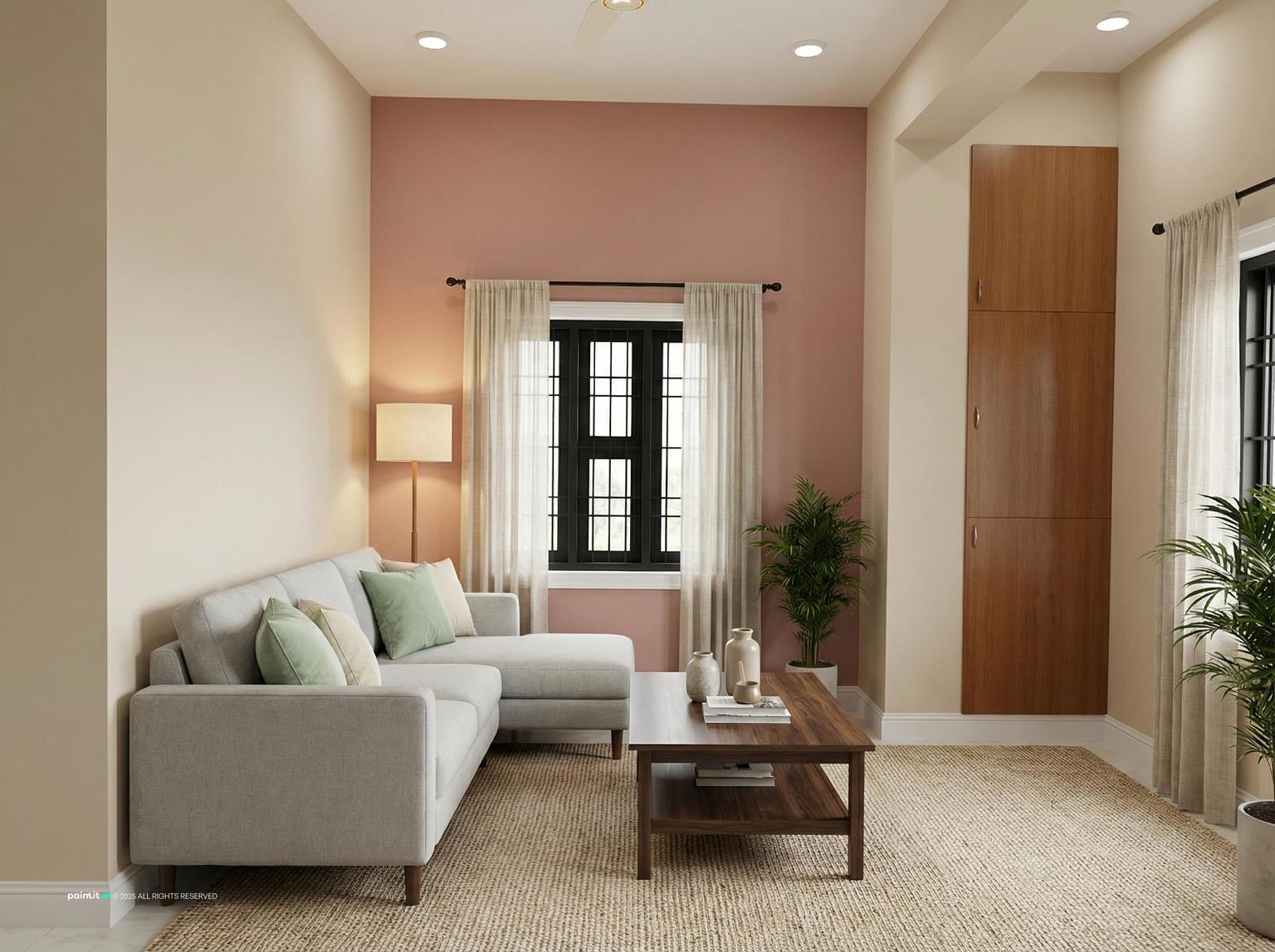 Grey sectional with pastel cushions in front of a soft pink accent wall