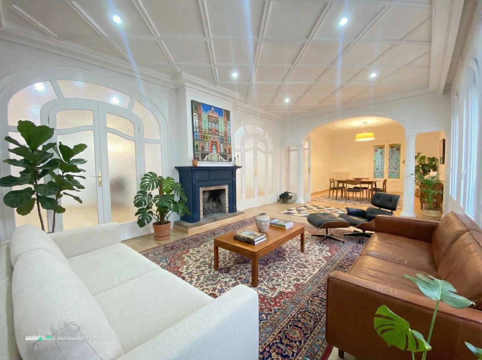 Formal living room with two sofas facing each other at right angles to a fireplace and a coffee table between them