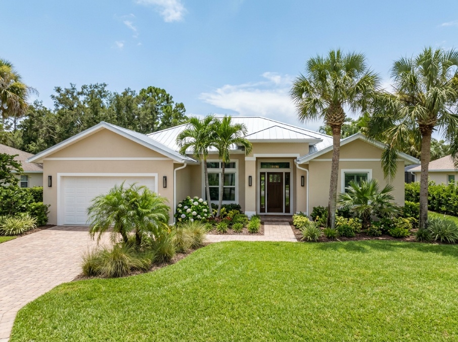 Florida stucco home repainted in sandy beige acrylic exterior paint.