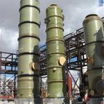Three medium diameter FRP tanks being installed at a chemical processing facility.