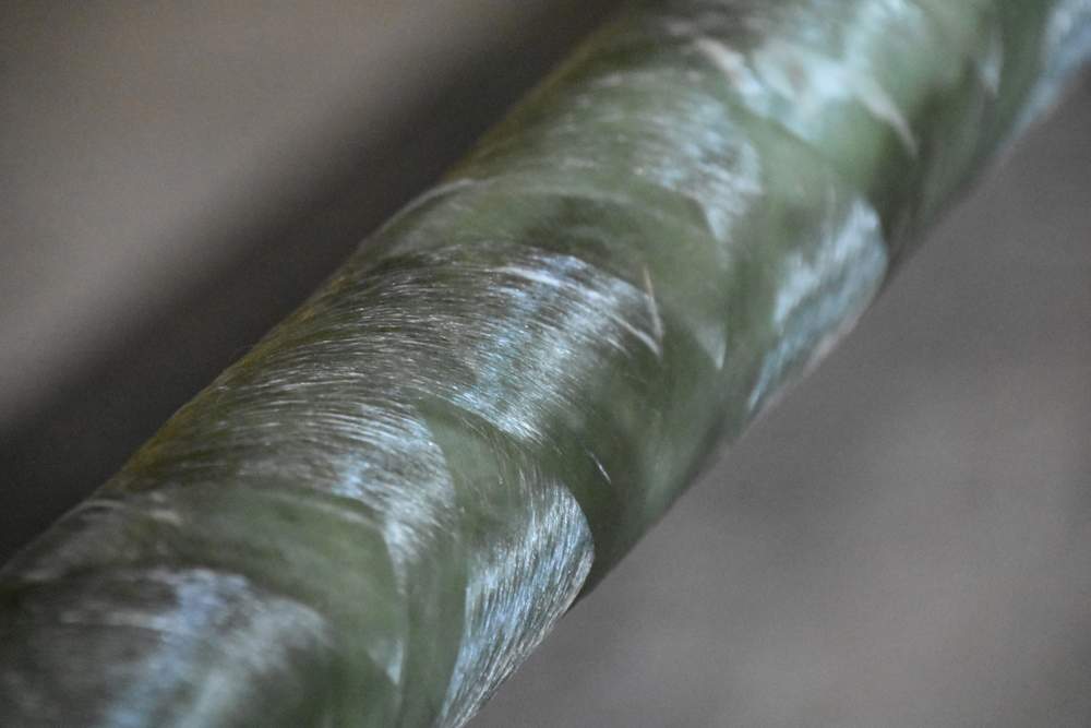 Close up of a fiberglass pipe after being filament-wound