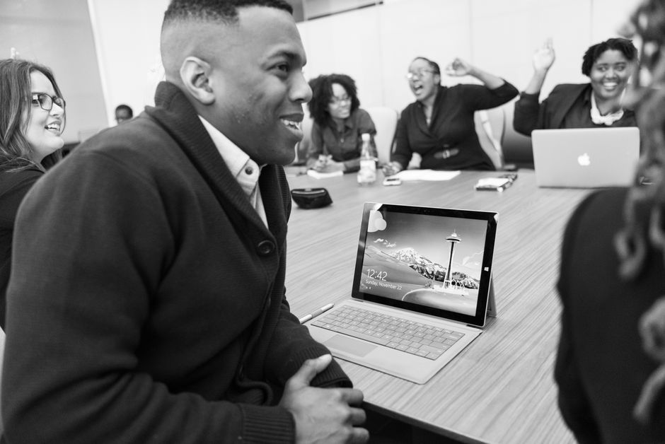 Group of colleagues enjoying a lively discussion in a modern office