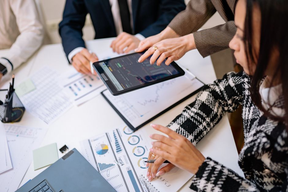 Business professionals reviewing analytics on a tablet