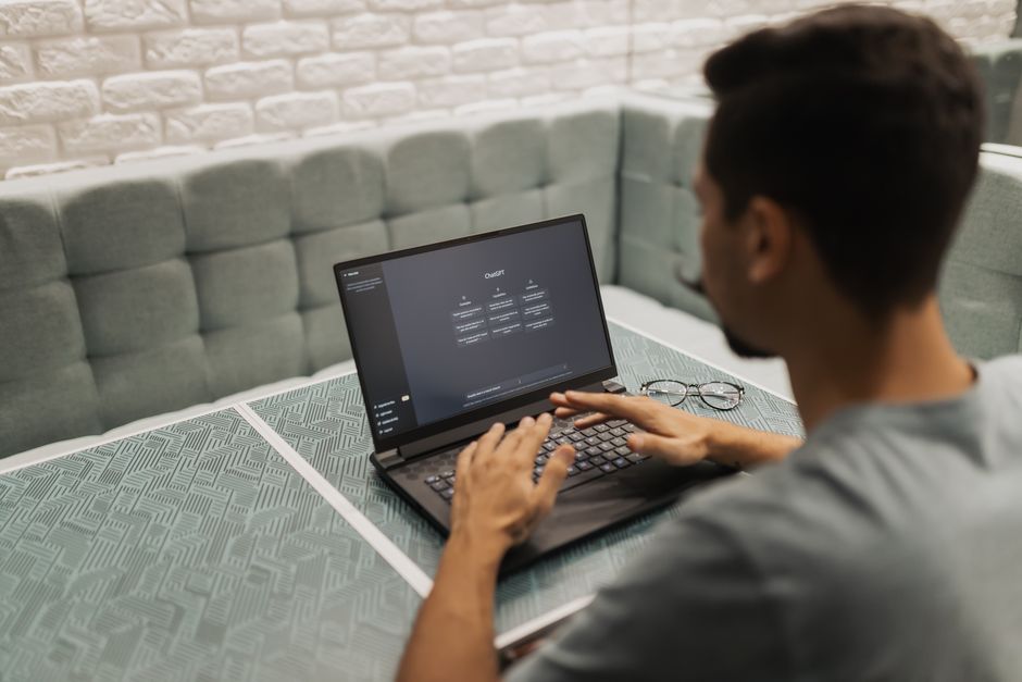 Person using Languza AI tutor on laptop in modern office