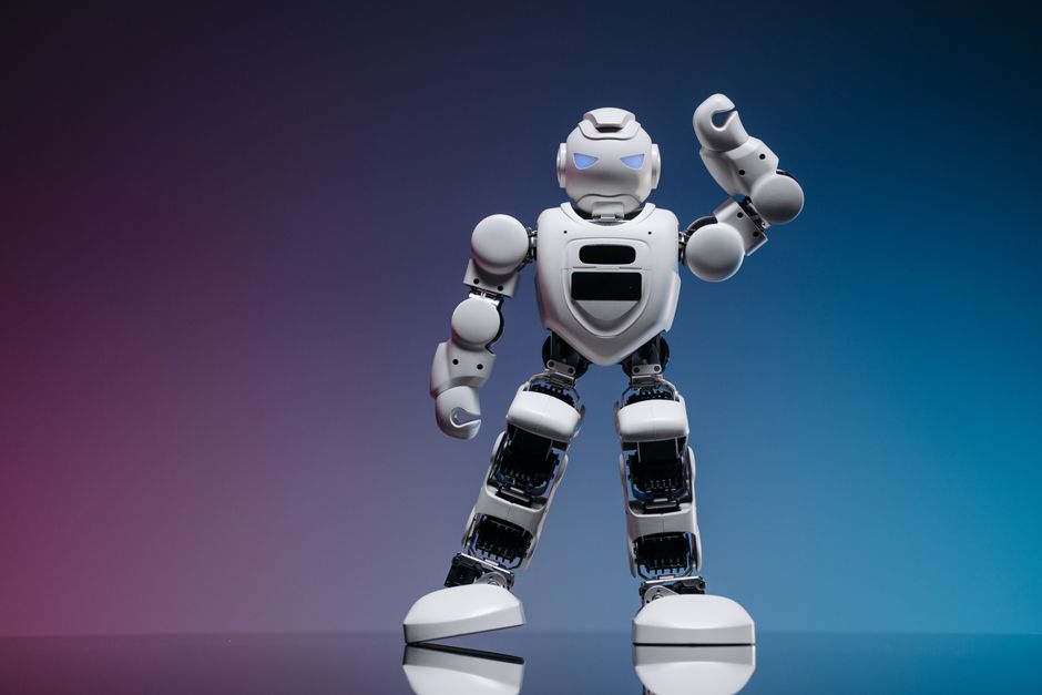 Sleek white robot in a studio setting against a gradient background