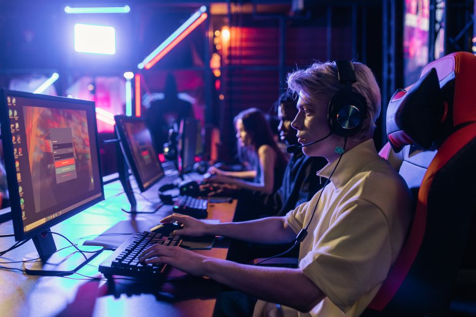 Gamers engaged in a competitive session, equipped with headsets