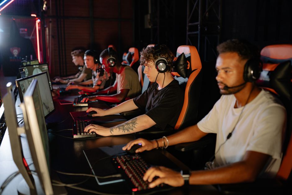 Group of focused young gamers playing in an intense esports session
