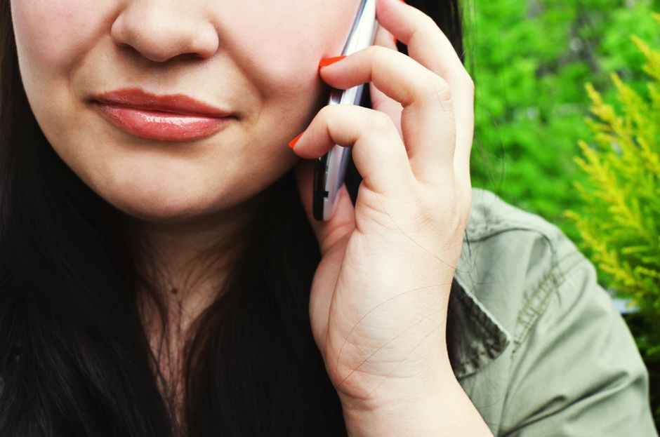 Woman chatting on smartphone outside