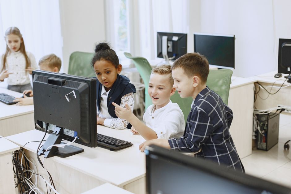 Students engaging with computers in a modern classroom
