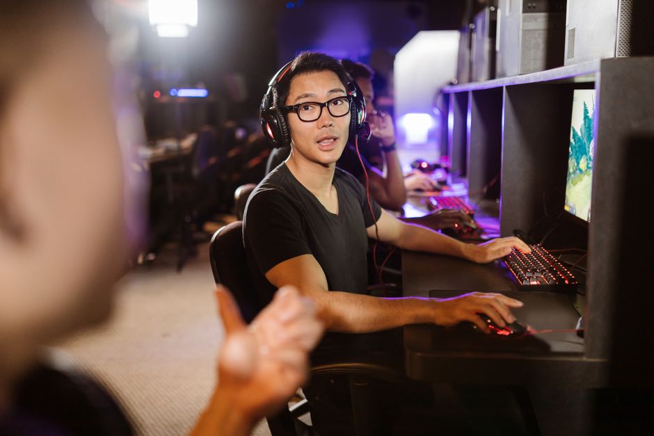 Adult men engaged in competitive video gaming at a modern arena
