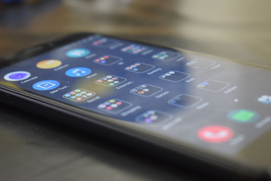 Close-up shot of a smartphone screen showing various app icons