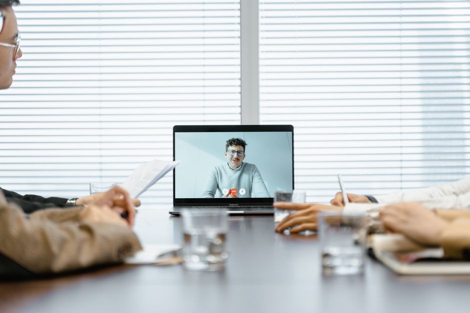 Professional in a virtual meeting on multiple devices