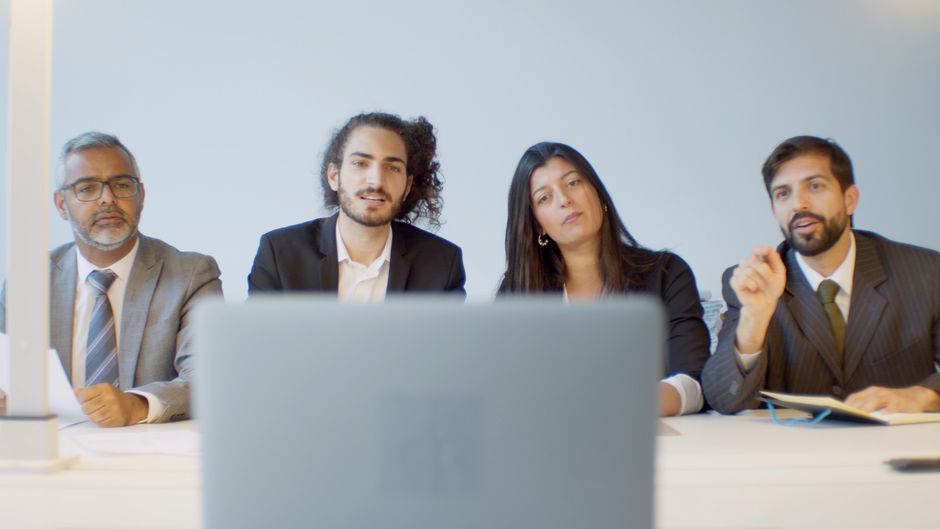 Diverse team of professionals in a meeting discussing with focus