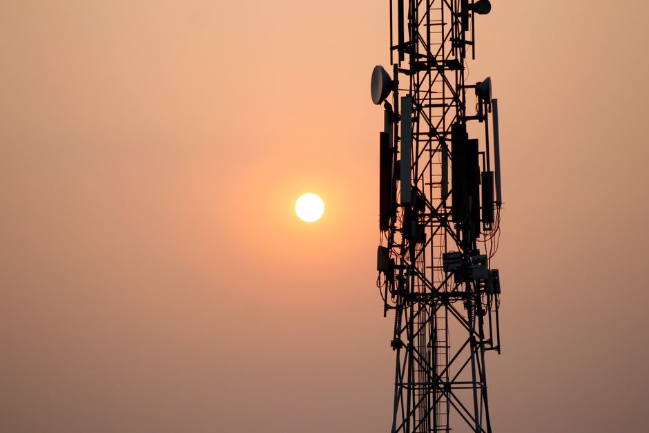 Silhouette of a communication tower against vibrant sky