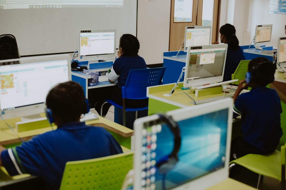Children engaged in learning at computers