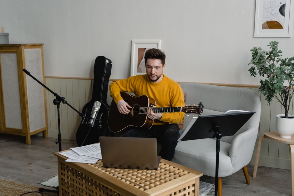 Man playing guitar in living room