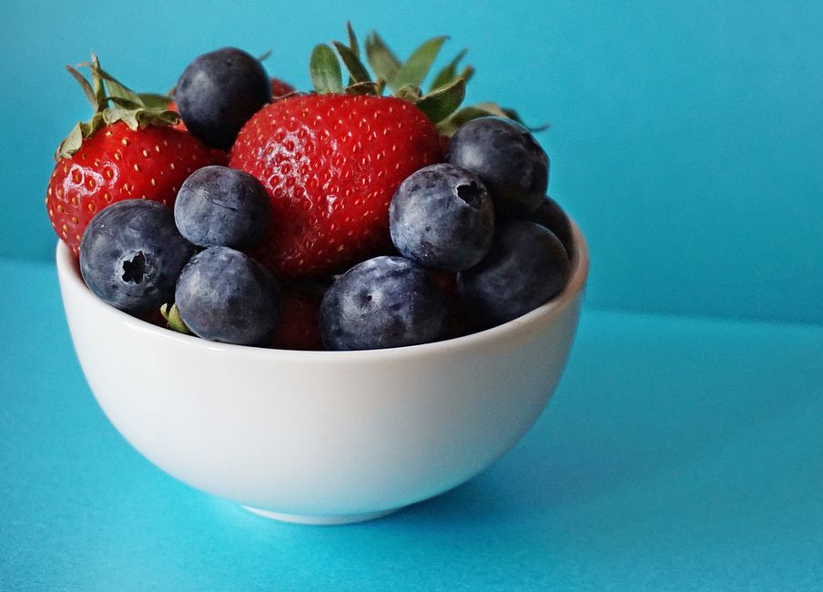 Bowl of mixed fresh berries with strawberries, blueberries, and raspberries