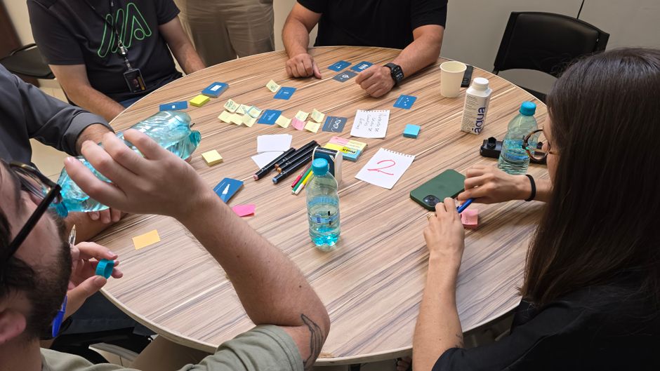 Group of adults collaborating at a round table with sticky notes