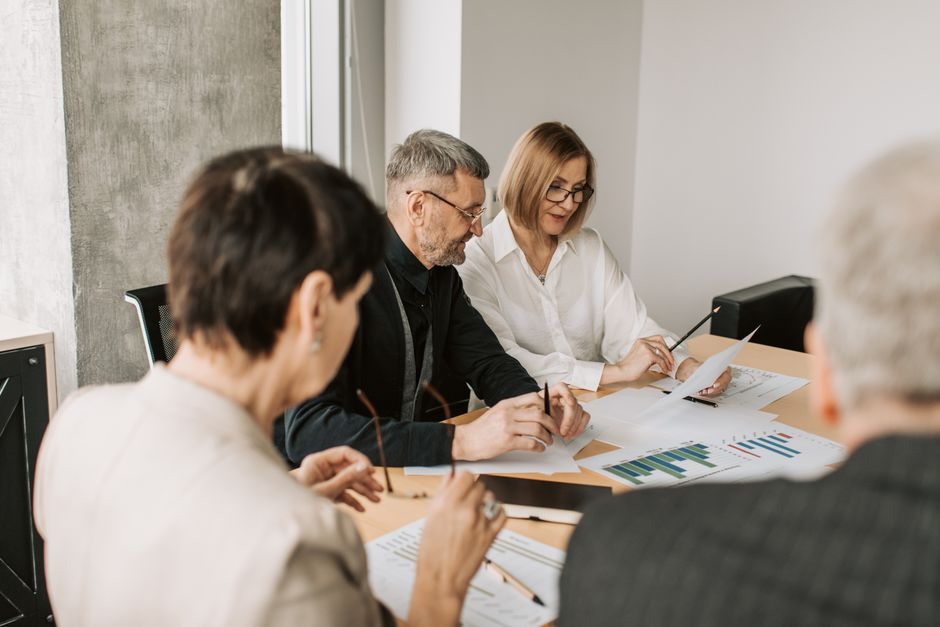 Team of professionals in office analyzing financial documents