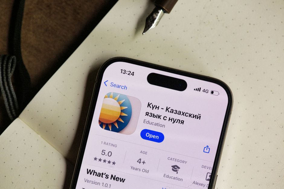 Close-up of a smartphone screen showing a Kazakh language learning app